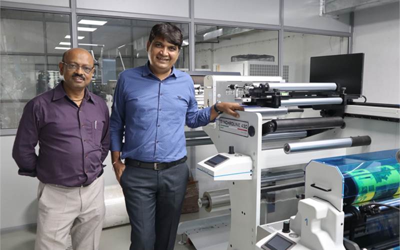 (l-r) Manish and Minesh Patel of Shreedhar Labels with Lombardi Synchroline narrow-web printing press
