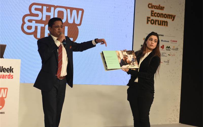 Raahhul S Zawarre of Zaware Creative Enterprises demonstrates the company brochure which has incorporated all the finishing processes that the company offers to its customers, especially in terms of special post-press processes