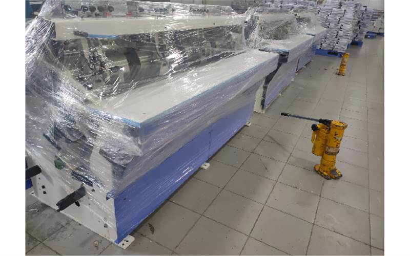 Despite the rigours of transport and movement of the consignments from the ground to the first floor, it was a scratch-less installation. The plastic shield ensured it. Here the gathering modules are aligned (four modules provide 16-stations) to the Binder. It took 10 hours and five people to complete the unloading, unpacking, lifting and placing