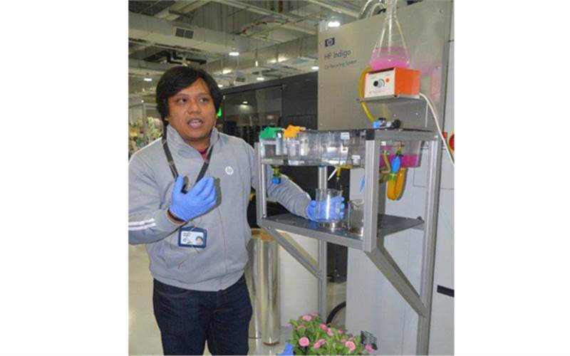 A HP Indigo representative demonstrates how the Indigo presses are fitted with green mechanism and have the capability to recycle the water used during printing process