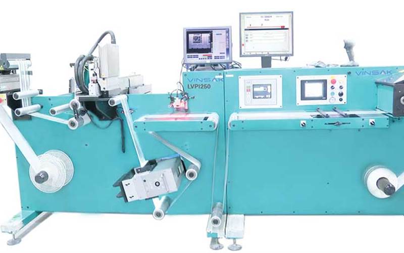 Vinsak LVPI - Creed Engineers: Launched in 2013, the LVPI has six units installed at government sites in South India, where Creed claims, 20 crore tax stamps are personalised every month. The monochrome machine can print at 600x600dpi on tax stamp labels, commercial labels, and scratch cards. Expect this platform to move from a monochrome label press to a multiple heads press as well as choice of inkjet systems beginning 2015. Also see Vinsak LSR, a 450mm wide label slitter rewinder with new value added features.
          Stall No: J11