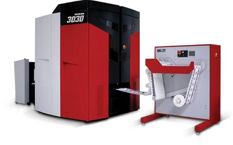 Xeikon 3030 - Xeikon: The company will entice you with this: ‘If you are a label converter looking to foray into high quality digital production of labels, 3030 is the machine’. And, there are reasons for that. The Xeikon 3030 is the narrow web entry-level press of the Xeikon 3000 Series, the largest range of digital label press offerings available on the market today. The full rotary five-colour Xeikon 3030 has a variable web width ranging from 200 mm up to 330 mm. It runs at a top speed of 9.6 m/min and can handle production volumes of up to 190 sqmtr/hour and uses food approved dry toner technology. The company’s most famous installations are the ones at Webtech Labels and Better Labels. Also see the self-adhesive label suite, an integrated solution to print and convert self-adhesive labels, developed in collaboration with its Aura partners.
          Stall No: D25