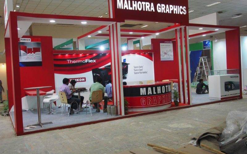 Malhotra Graphics' stall in their customary red being readied for the show. The Mumbai-based firm represents various overseas manufacturers.