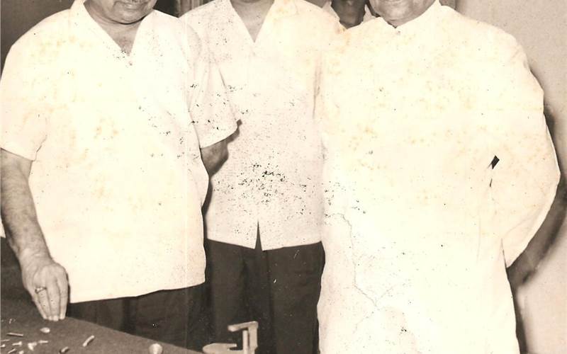 Marathe (l) demonstrating Swifts-manufactured automobile parts to Seth Lalchand Hirachand Doshi (r)