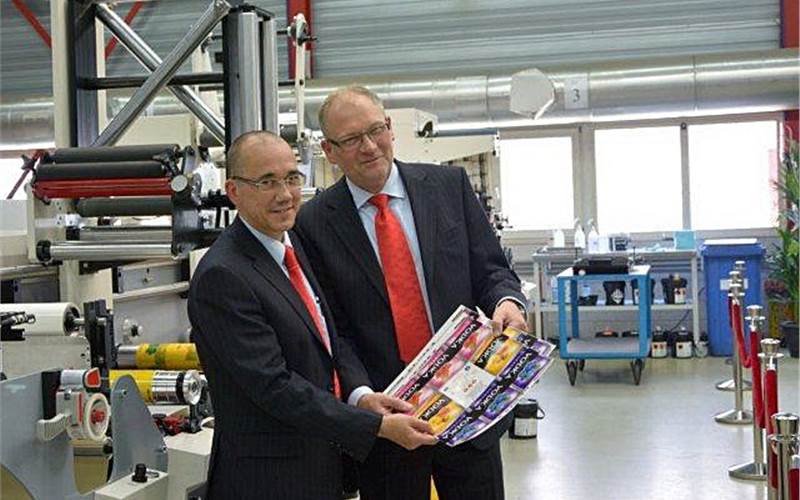 Eric Hoendervangers (l) and Bert van den Brink, founders and co-owners of MPS, with a print taken on its newest narrow-web flexo press, the EB 370. Hoendervanger manages sales and marketing while Brink handles R&D and production.