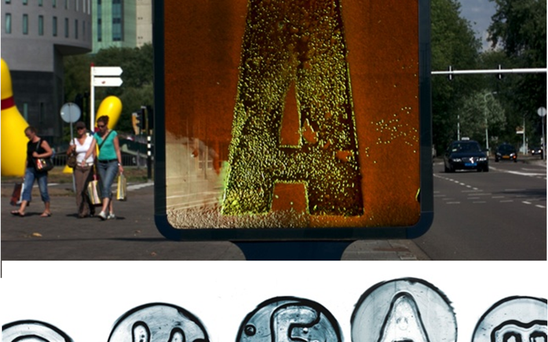 A project named Symbiosis by Jelte van Abbema wherein bacteria are injected in advertising board. The bacteria germinates and the colour of the board changes everyday. He also created the bacteria font.