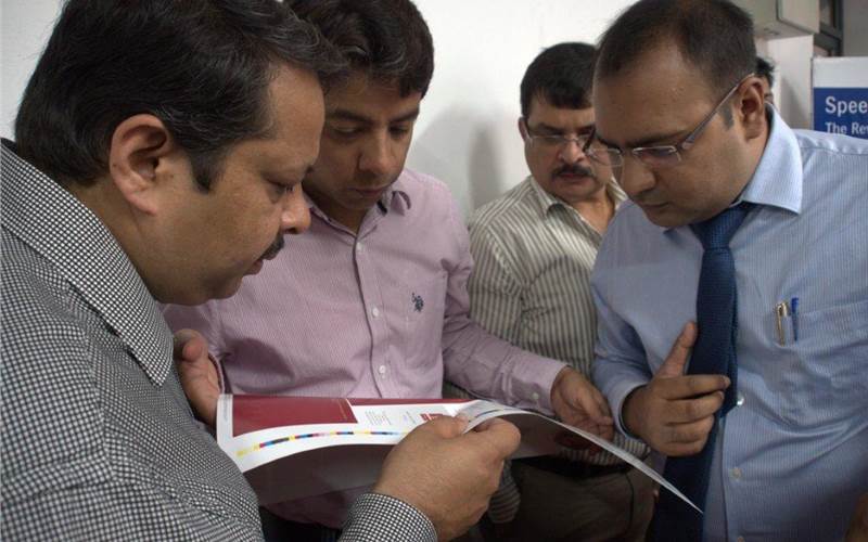 In the picture are Gulati brothers(l) of Galaxy Offset discussing Anicolor's print consistency across the sheet width, which was achieved within 20 makeready sheets