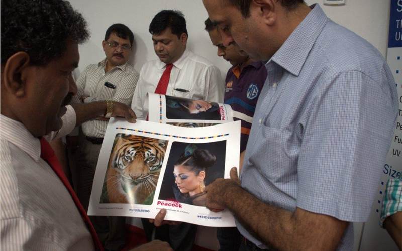 Sanjay Bajaj of Bengaluru-based digital print firm PrintXpress, examines the Anicolor-printed sheet during the demonstration