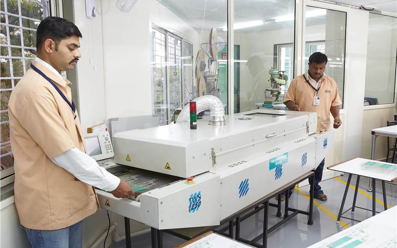A TWS conveyor IR oven cures the conductive inks on PET films
