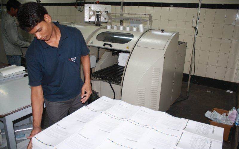 Section-sewing operator examining the stitched sections