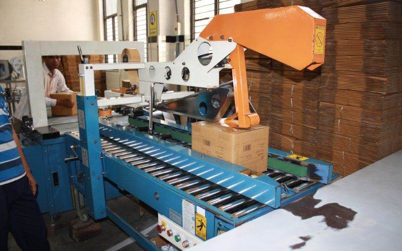 The books are packed using tapes and filled in corrugated boxes before they are loaded for palletisation process