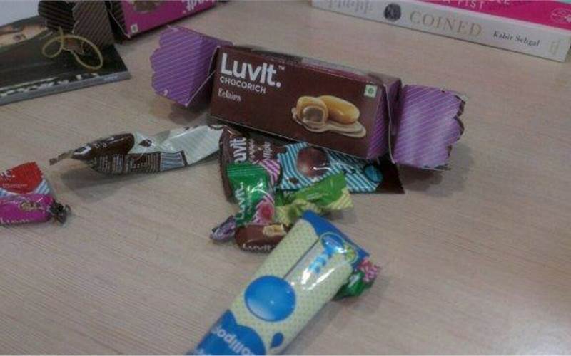 Chocolates are made in all hues but rarely does the box reflect it. When have you seen a round or a square box? How many Kit Kat or Godiva type packaging has one encountered. But this one brand - LuvIt - has marched forward and backward (into nostalgia – and integration) at the same time. The items of confectionery come in a toffee shaped box and the two ends open with a twist - as simply as you would unwrap the humble toffee. Just the way it should have always been with the chocolate boxes ... This is a brilliant example of a superb use of die-cut complemented by folding and pasting. The only downside: You can keep a tab at how many toffees have gobbled up from the see-through window patch! All for a sweet tooth!
