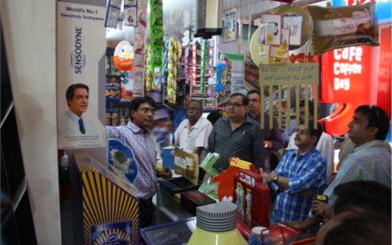 Amit Shah standing in the kirana shop created at the Bazaar and provides a first-hand experience of the POPs created by Spectrum Scan