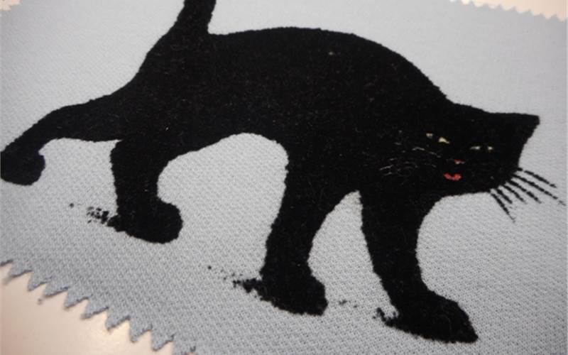 Plastisol plus lock print
          Print process: After the three base colour is printed, black flock powder is applied in a flocking machine. Past which print is cured