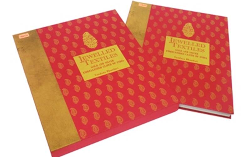 LUSTRA PRINT PROCESS | Jewelled Textiles Length of run: 3000Design: 214 pages + eight end pages + outer laminated cover with hard case cover and sleeveArt: CMYK on the inside pages, gold screen printing on the cover and the boxPre-Press: Screen CTP system and the Agfa Apogee Pre-press ManagerPress: Ryobi 925 (five colour plus online aqueous coater)Post-Press: Gold screen printing on satin cloth and one book markPaper: 170gsm Magno matt art paper for the text and end pages. For the cover, satin cloth was pasted on 3mm kappa mill board, and for the box satin cloth was pasted on 3mm kappa mill board