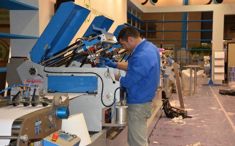 A Cartes label machine in the GT series being set up. Cartes was reportedly the fist to produce a digital die-cutting and converting machine. Cartes is the only semi-sealed laser machine in the reel to reel market. The same laser technology is applied in combination with screen printing, hot-stamping, embossing, flexo varnishing and die-cutting units