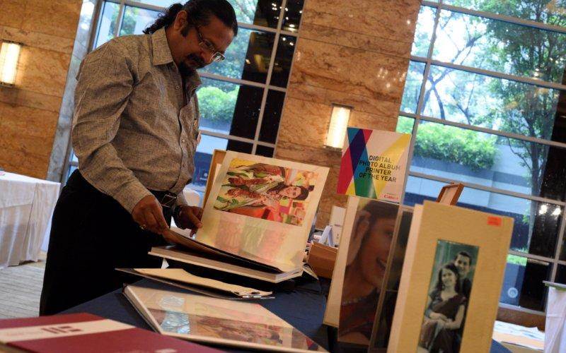 Hemant Randive of FCB Ulka Advertising admires the samples. He said, "We print offset at 300lpi, we print digital at 2400dpi, we have the ISO standards, so our print is as good as you will get anywhere in the world."