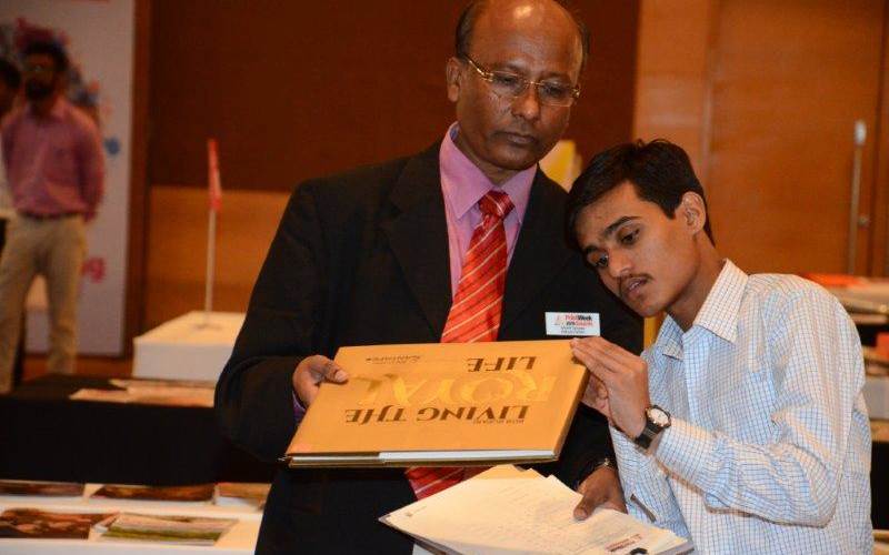 Manik Salunke of Kokuyo Camlin and Sainath Mane a student-intern from SIES College examine if the binding is perfect