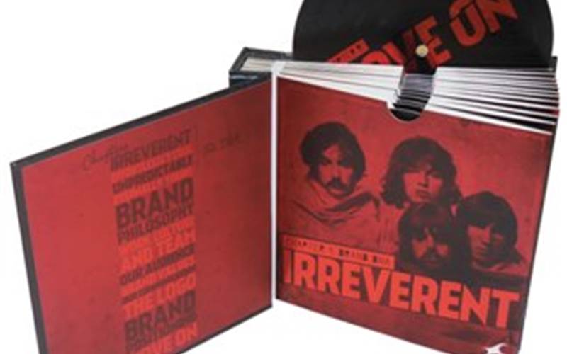 PRAGATI OFFSET | Fastrack - brand boxLength of run: 200Art: CMYK + WhitePre-Press: Output on CTP using 200lpi screeningPress: Mitsubushi Diamond 1000 UVPost-Press: Matt lamination for slipcase box and printed laminated cover. met-PET lamination and online textur UV for pouches and discs. Matt silver foiling and spot UV for box. Spot UV on file folderPaper: 170gsm art paper for slipcase box and hardcase. 200gsm maplitho for slipcase inner side. 250gsm coated folding box board for pouches and discs. Kappa board for case and box.Special Feature: The customer wanted their brand book to look like an old set of analog LP disc. They used a worn, grunge look for the entire piece. The discs were made using double pasted CFB board for thickness