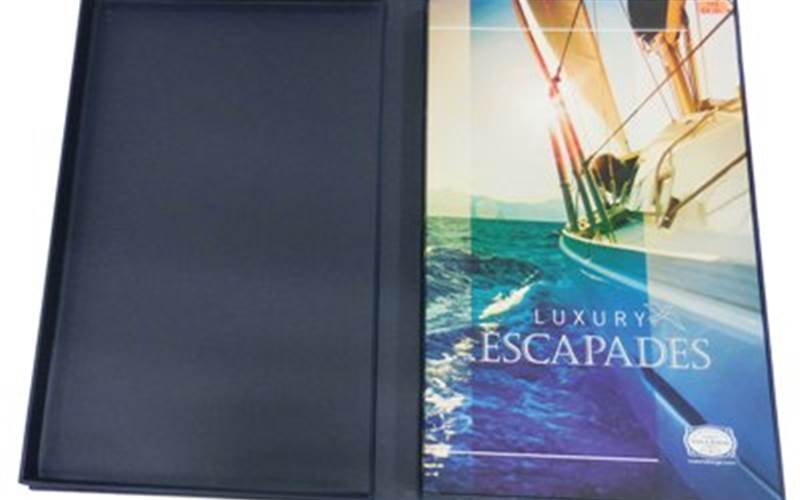 JAK PRINTERS | Luxury EscapadesLength of run: 2000Art: CMYK + online aqua gloss varnishPre-Press: Heidelberg Prinect workflow, Suprasetter CTP system, Epson Stylus Pro 9880, EFI Fiery XF, Glunz & Jensen Raptor Pro 85tPress: Heidelberg Speedmaster CD102-7+LX (28×40, seven-colour plus coater)Post-Press: Hardcase cover - thermal velvet lamination done on BEW Thermolam 800R and spot UV. Hardcase cover making and book block fitting done manuallyPaper: GardaPat 13 Kiara paper from Transasia Fine Paper for the text pages and Magno Satin from Sappi for the coverSpecial Feature: Section sewing done on polygraph