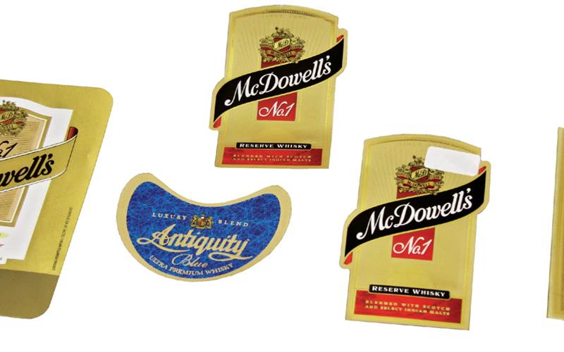 PrintWeek India Label Printer of the Year 2011 - Manohar Packaging. An array of processes were involved for producing the Signature Rare Whisky label which involved printing on Omet narrow-web press, double hot foil stamping, micro and deep embossing, and die-cutting all in one pass on 80 gsm mirror coat paper